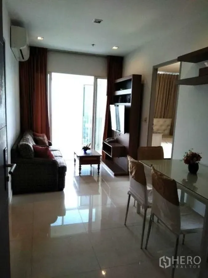 公寓 出租在Watthana, Bangkok - 客餐厅一体，连接明亮阳台，自然采光充足。