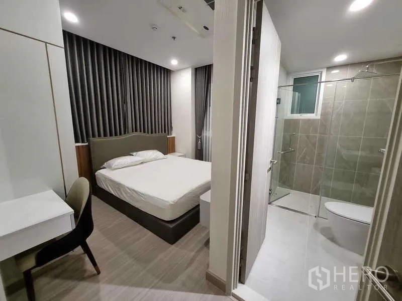 Condominium for rent - Master bedroom with ensuite bathroom showcasing a glass shower.