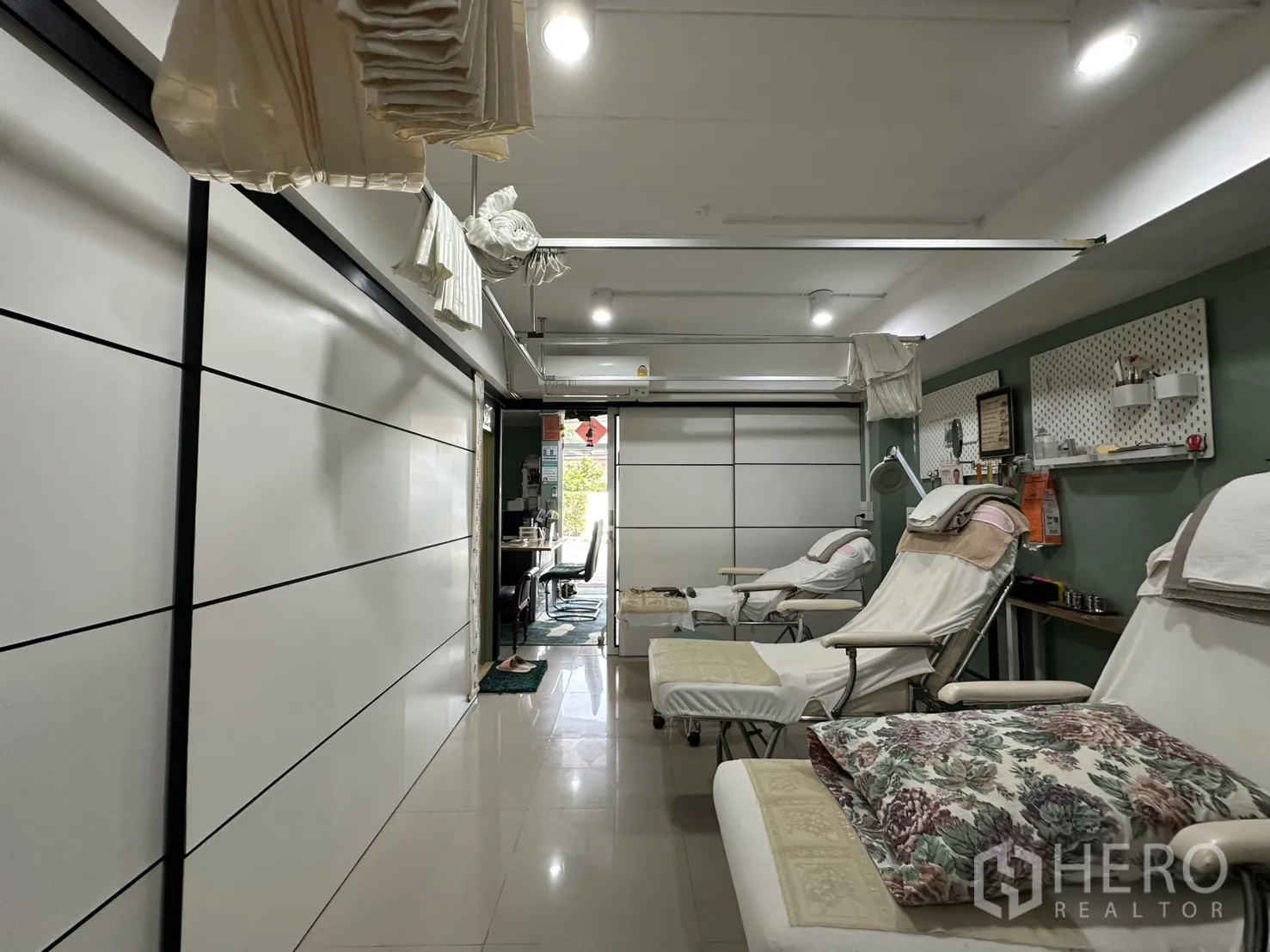 Shophouse for rent in Phra Khanong, Bangkok - Long open-plan room with recliner beds and white sliding partitions.