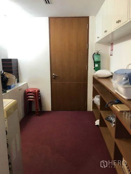 Office Space for sale in Watthana, Bangkok - Pantry or utility room with shelving, red carpet, and fire extinguisher.