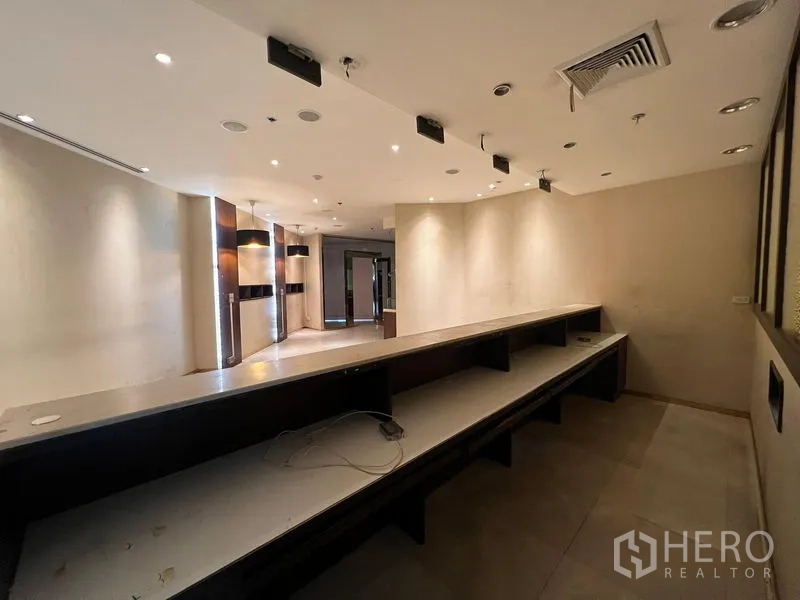 Retail Space for rent - Back-of-house workspace with an extended workbench and shelving behind the service area.