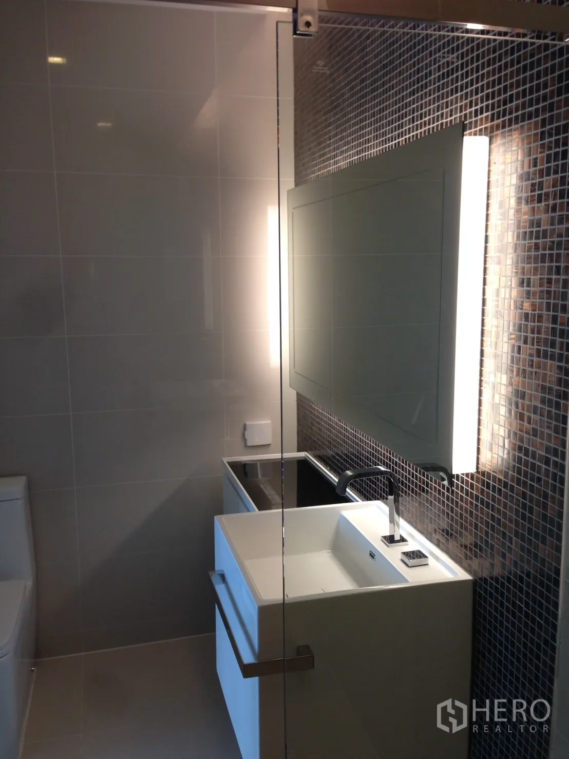 Condominium for rent in Bang Sue, Bangkok - Second bathroom with glass partition, designer sink and mosaic accents.