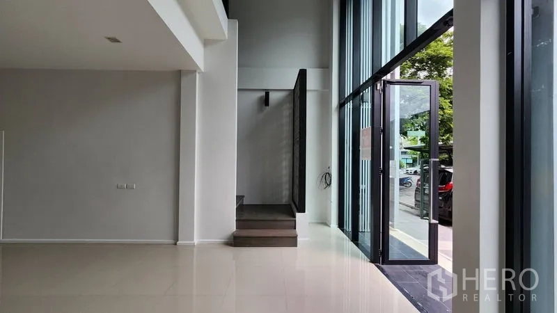 Home Office for rent - Entry area with tall glass storefront and door beside the stairs.