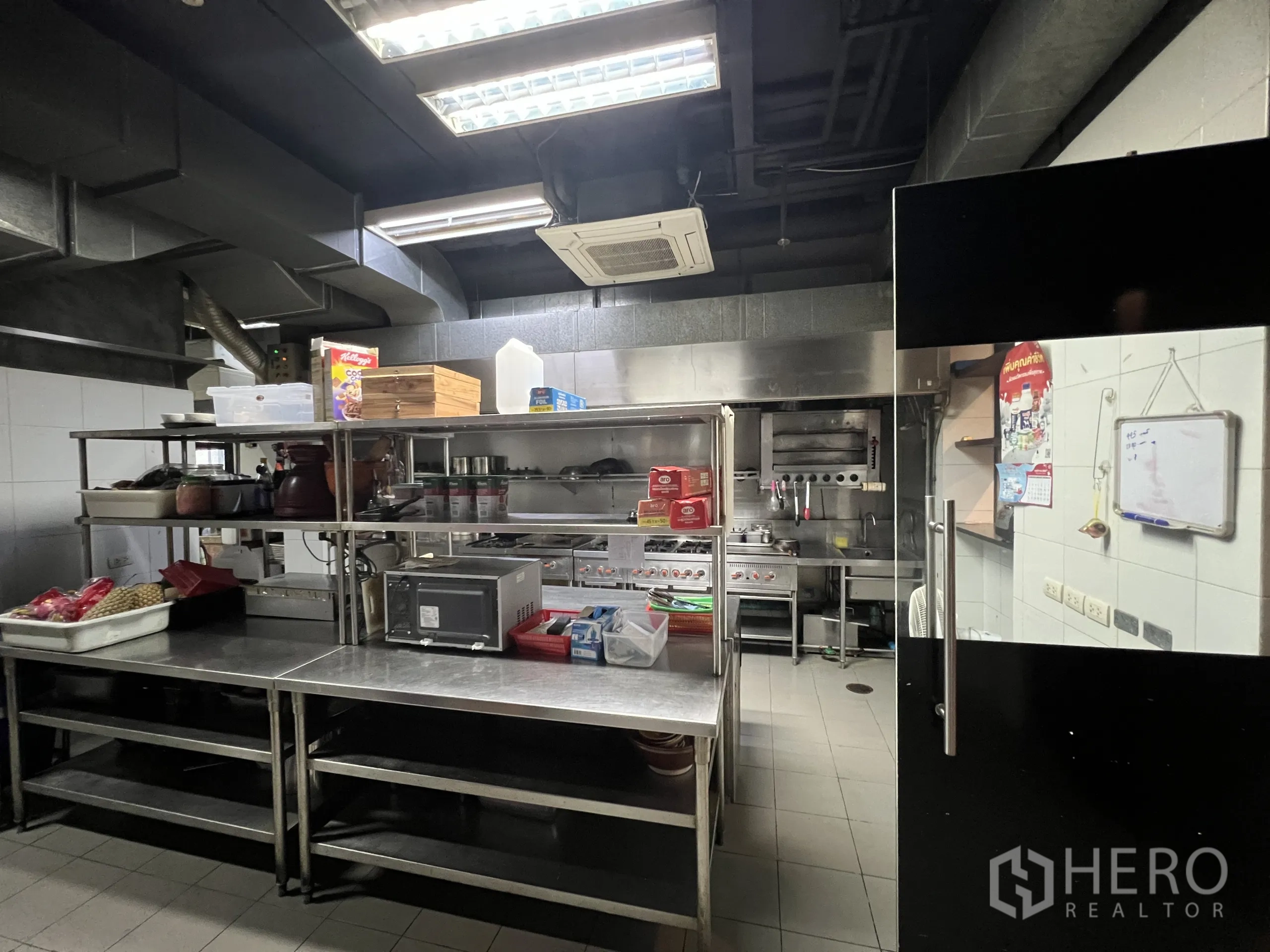 Retail Space for rent in Watthana, Bangkok - Commercial kitchen with stainless worktables, stoves, ovens, and strong ventilation.