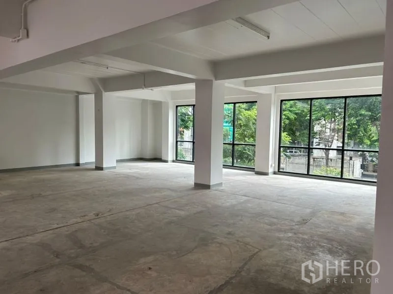 Office Space for rent in Bang Rak, Bangkok - Corner office space featuring wraparound windows overlooking greenery.