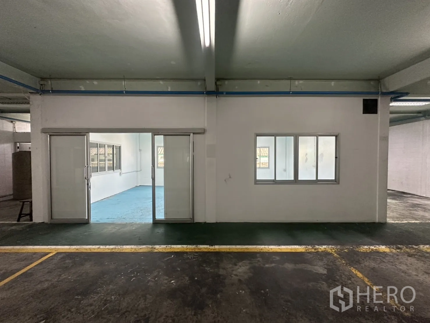 Warehouse for rent in Bang Na, Bangkok - White internal office pod with sliding glass doors and windows.