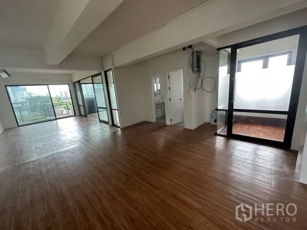Office Space for rent in Sathon, Bangkok - Open office featuring an in-suite restroom, wiring cabinet, and a glass-partitioned room leading to a balcony.
