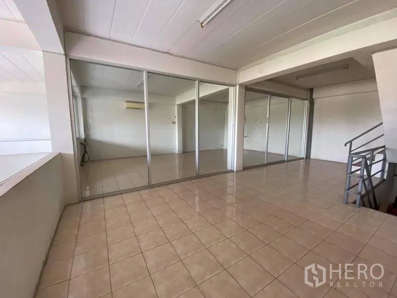 Factory for sale in Bang Phli, Samut Prakan - Glass-partitioned office rooms with tiled flooring inside the factory.