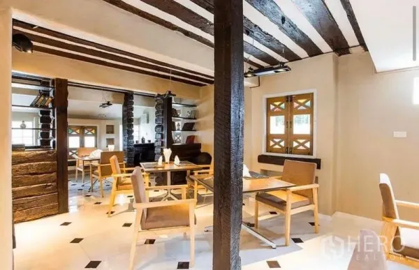 Retail Space for rent in Khlong Toei, Bangkok - Dining area with wooden tables, exposed beams and patterned windows.