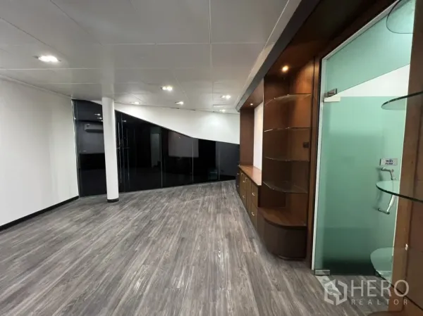 Retail Space for rent in Sathon, Bangkok - Finished showroom space with wood built-in shelving, frosted glass door and vinyl flooring.