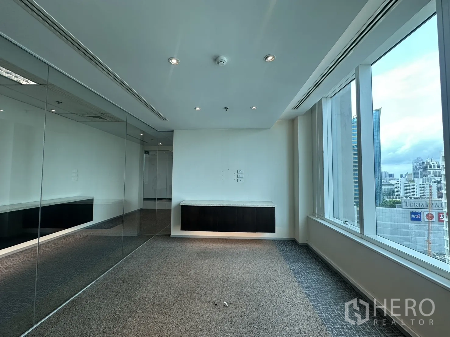 Office Space for rent in Watthana, Bangkok - Private office with floor-to-ceiling windows and mirrored glass partition.
