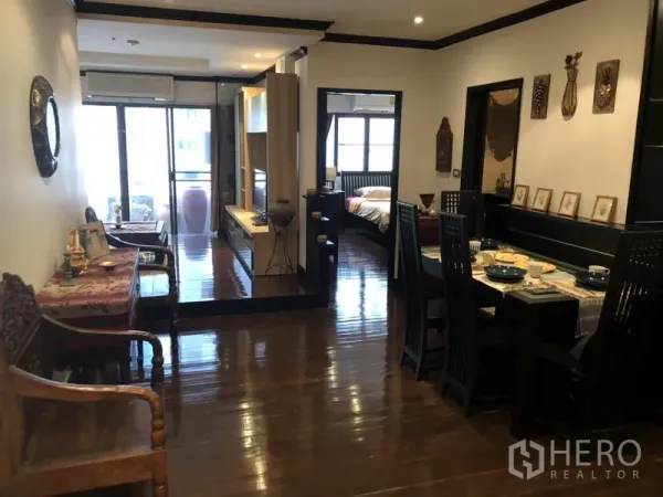 公寓 出租在Watthana, Bangkok - 木地板的餐客一体空间，通往阳台与卧室的走廊。