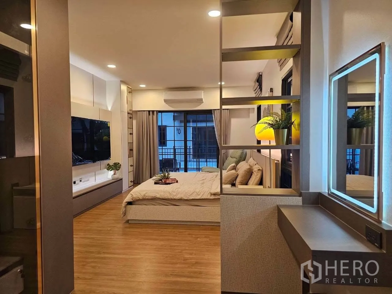 Detached House for rent or sale in Bang Phli, Samut Prakan - View across the bedroom to sliding doors, vanity, and TV wall.