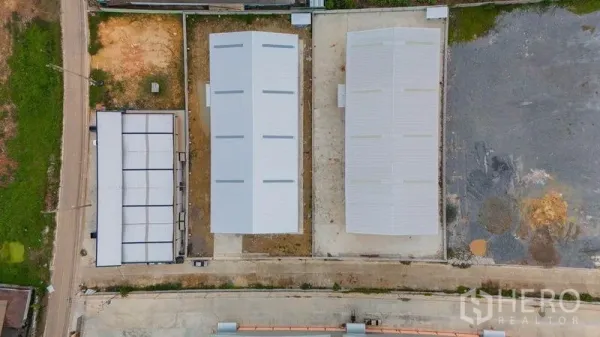Warehouse for sale in Krathum Baen, Samut Sakhon - Aerial view of a warehouse compound showing three long gabled roofs and driveway.