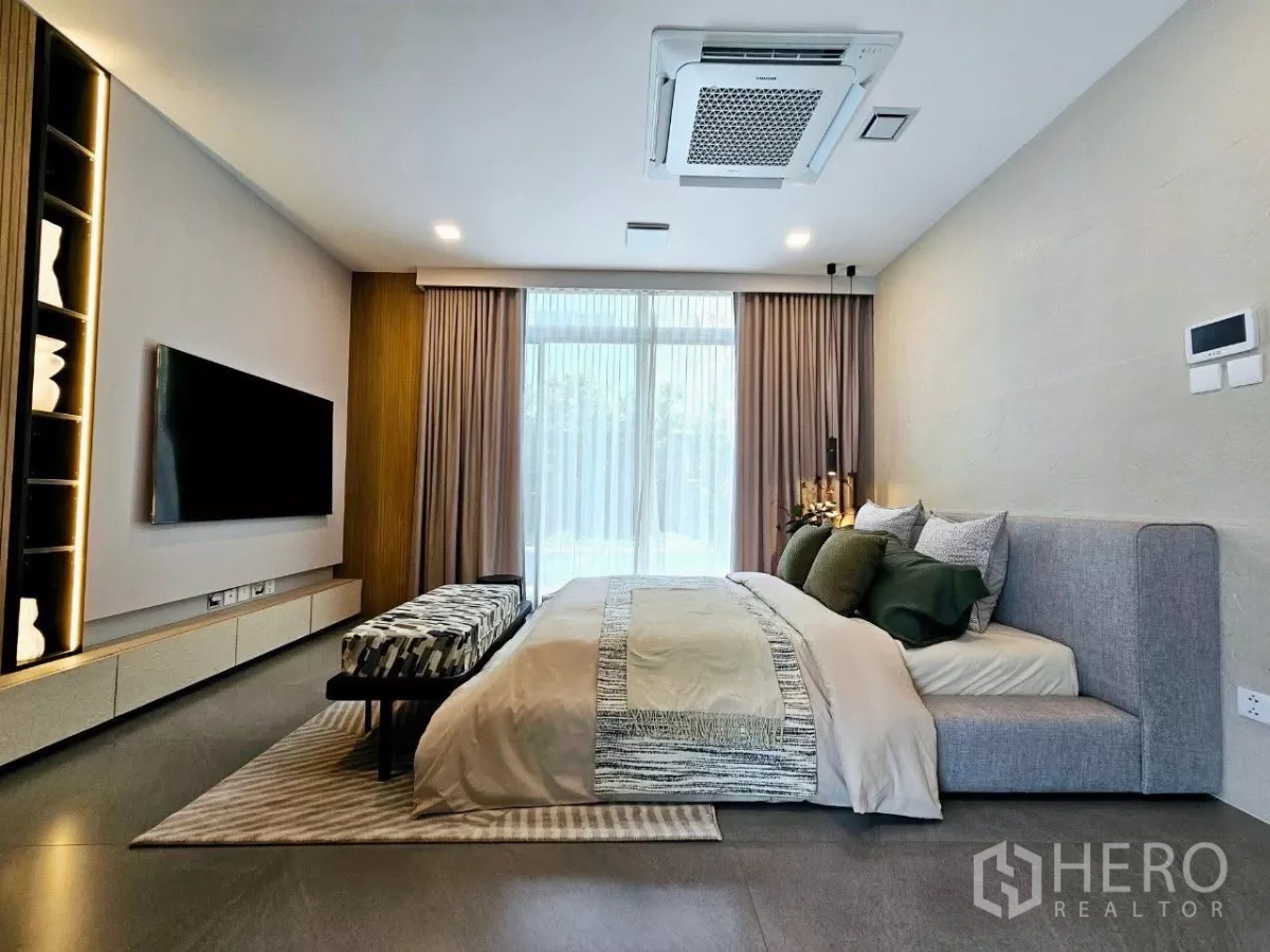 Detached House for rent in Saphan Sung, Bangkok - Primary bedroom with king bed, ceiling cassette air conditioner, and sheer drapes.