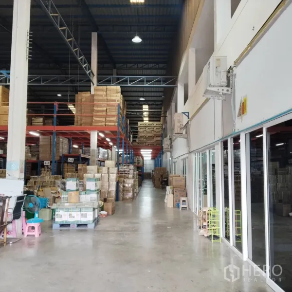 Warehouse for rent in Bang Khun Thian, Bangkok - Interior aisle with pallet racking and glass-partitioned office.