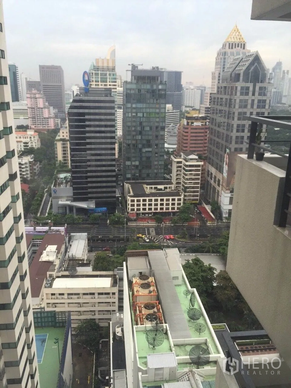 Condominium for rent or sale in Sathon, Bangkok - High‑floor balcony view of the Sathorn skyline and city streets.
