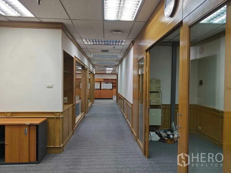 Office Space for rent in Din Daeng, Bangkok - Long corridor leading to glass-doored offices with wood frames.