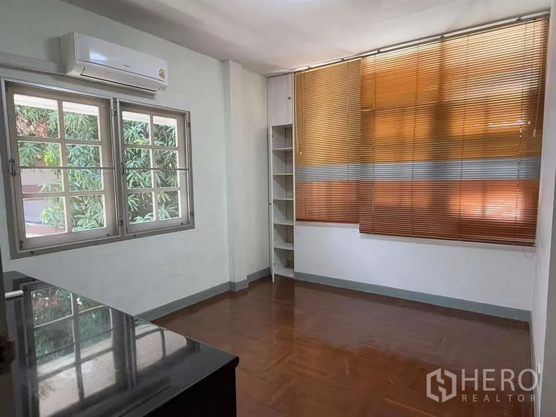 独立式住宅 出租在Bang Kapi, Bangkok - 明亮房间，带空调、转角置物架与带百叶的窗户。
