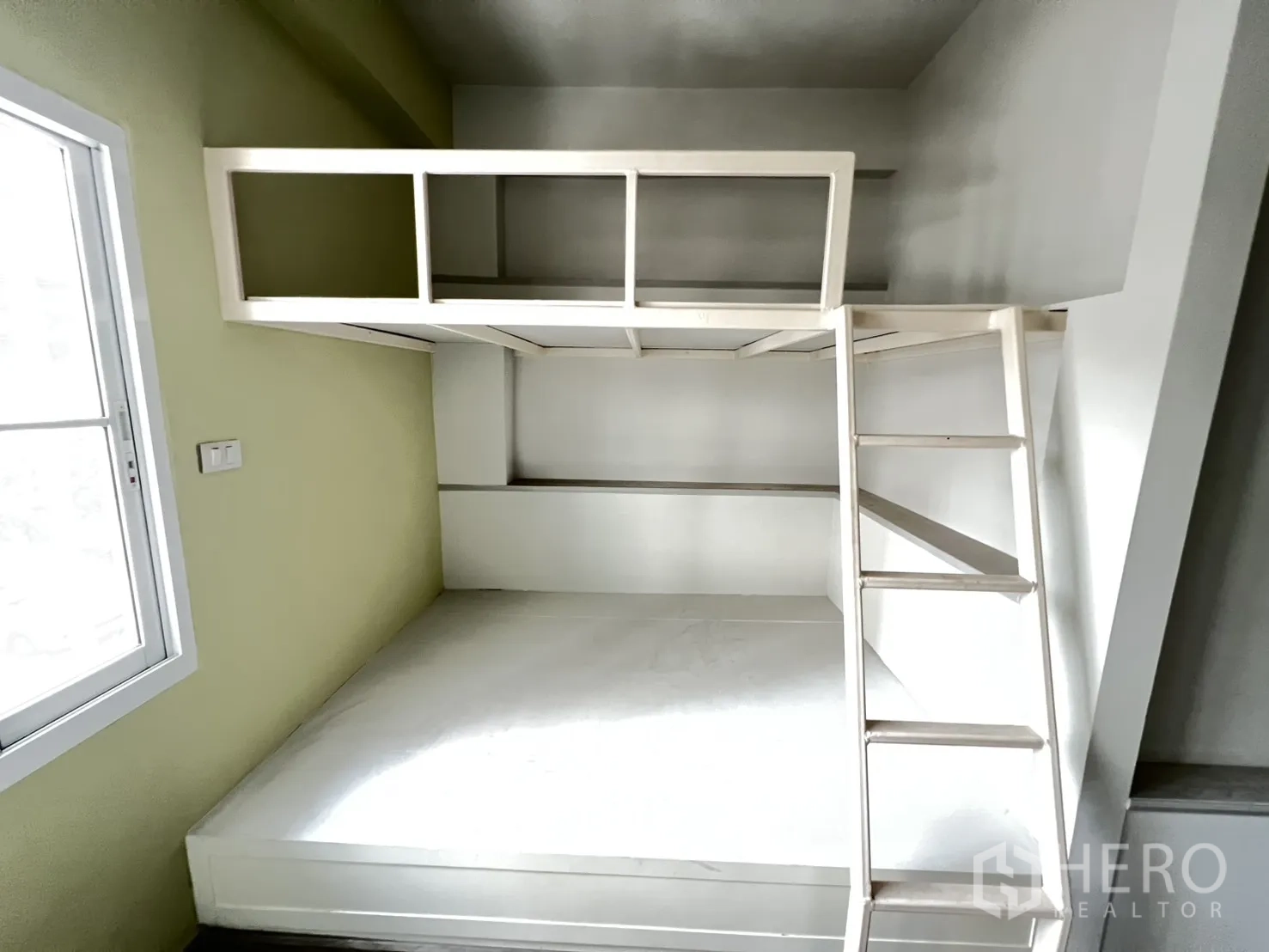 Shophouse for rent in Bang Rak, Bangkok - Bunk-bed room with large window, wood flooring and wall-mounted air conditioner.