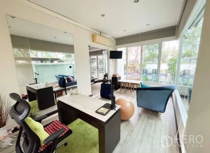 บ้าน ให้เช่าในBang Phli, Samut Prakan - ห้องทำงานผนังกระจกพร้อมโต๊ะ มุมนั่งเล่น และวิวสระกับสวน