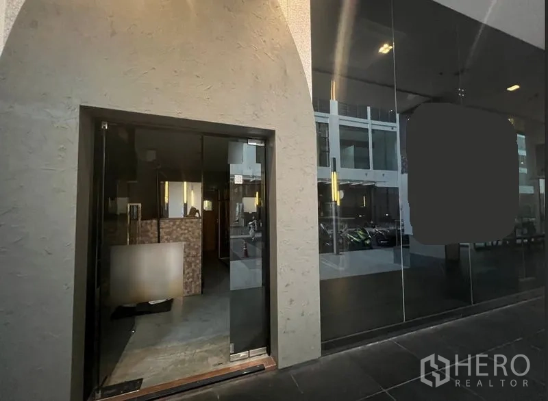 Retail Space for rent in Watthana, Bangkok - Street-level storefront with arched entry and floor-to-ceiling glass facade.