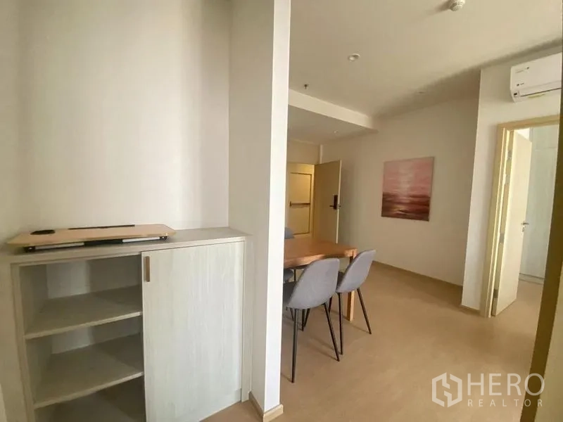公寓 出租在Watthana, Bangkok - 入户走廊带内置收纳柜，连接现代简约的用餐区。