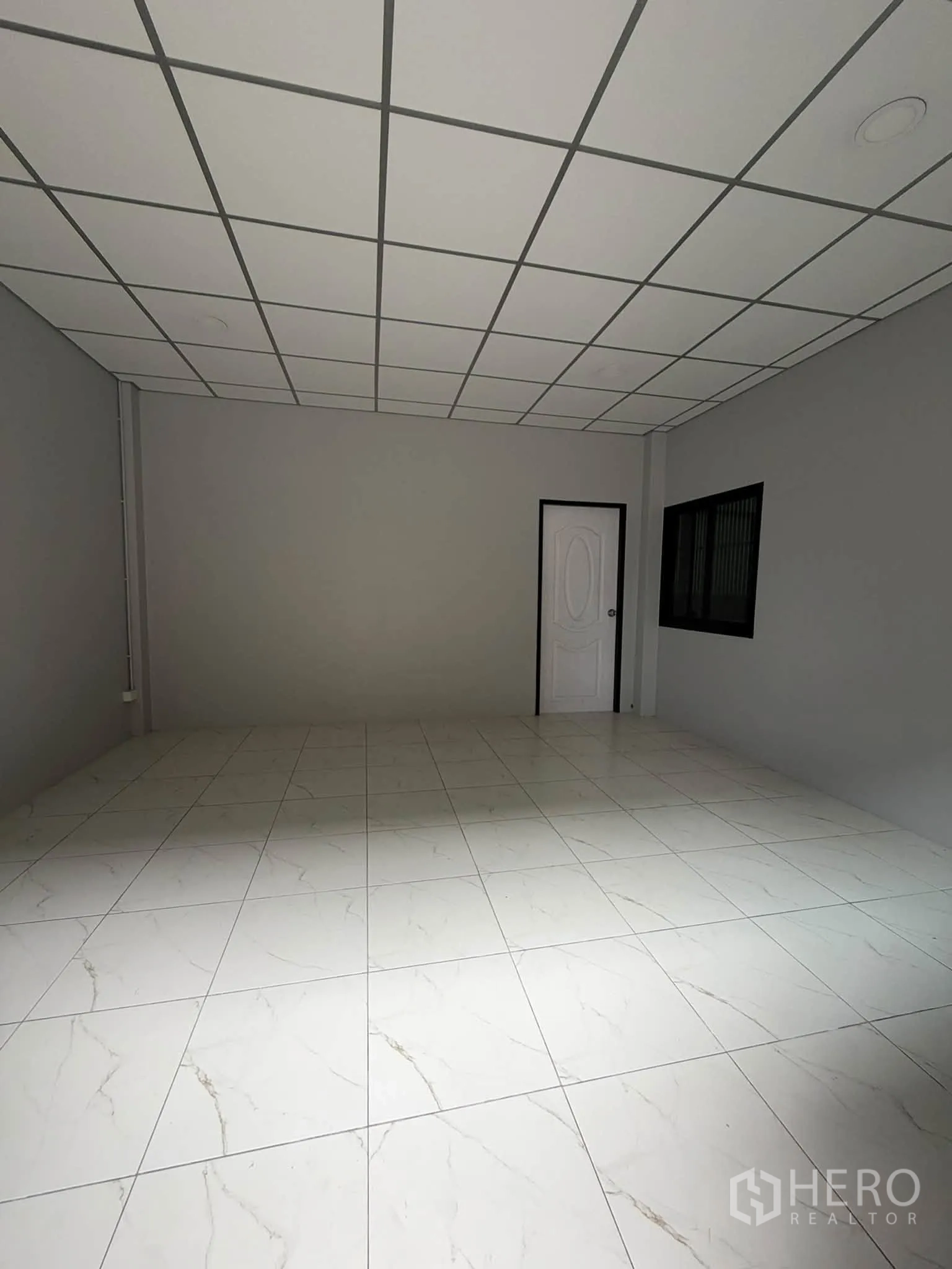 Warehouse for rent in Phra Pradaeng, Samut Prakan - Tiled office room with drop ceiling and an internal door.