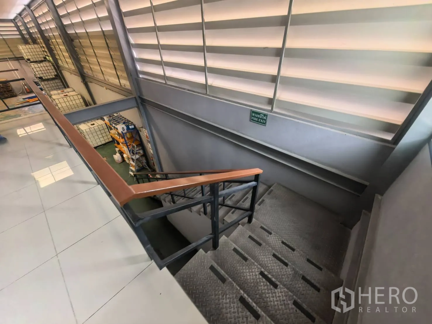 Warehouse for rent in Bang Sao Thong, Samut Prakan - Metal staircase with handrail leading to a mezzanine level.