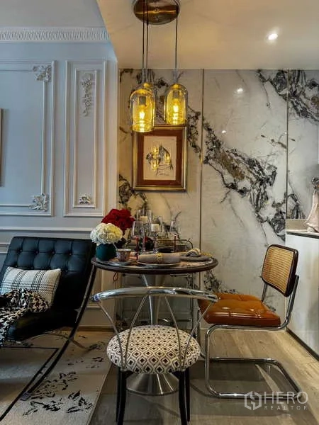 Condominium for rent - Dining nook with round table, pendant lights and polished marble wall panels.