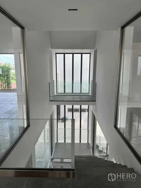 Home Office for rent or sale - View down the central stair void with tall vertical windows and glass balustrades.
