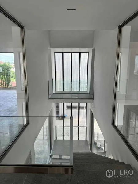 Home Office for rent or sale - View down the central stair void with tall vertical windows and glass balustrades.
