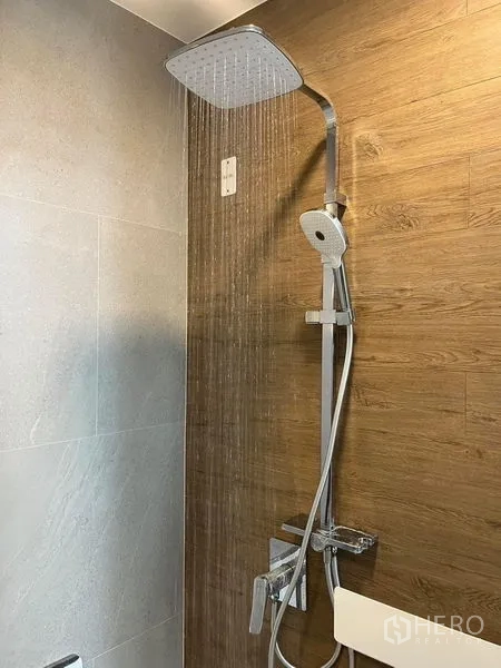 Detached House for rent or sale - Close-up of rain shower head and handheld on wood-look wall tiles.
