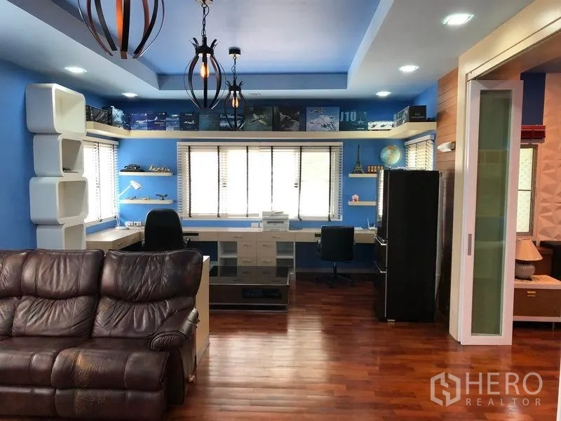 Detached House for sale in Wang Thonglang, Bangkok - Large study room with built-in workstations, shelving and a leather sofa.
