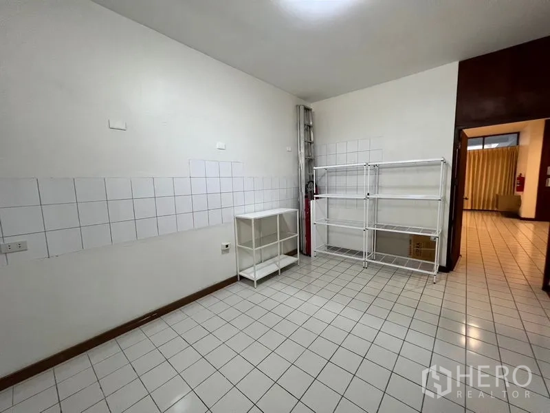 Townhouse for rent or sale in Suan Luang, Bangkok - Utility or pantry room with tiled walls and freestanding metal shelves.