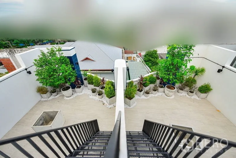 Home Office for rent or sale - Rooftop terrace with planters and city views accessed by a metal staircase.