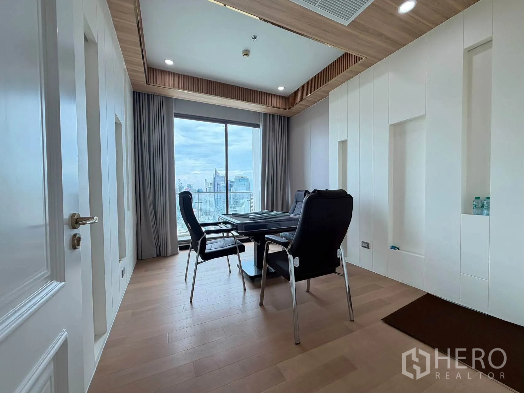 Condominium for sale in Watthana, Bangkok - Quiet study room with desk, two chairs, and city view through window.