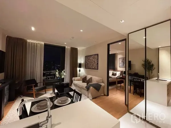 Condominium for rent in Khlong Toei, Bangkok - Open-plan living and dining area with city views through large windows and access to the bedroom.