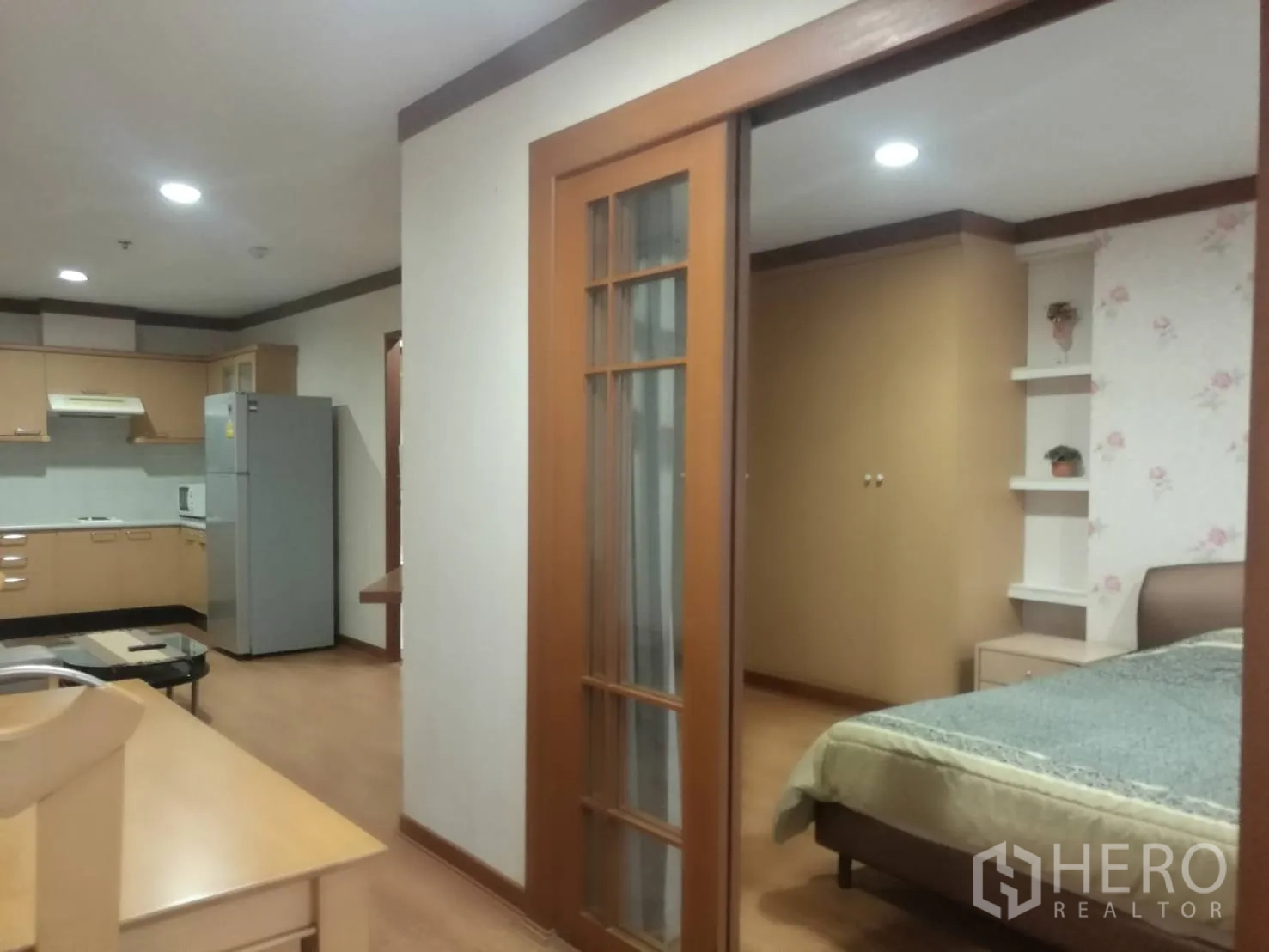 Condominium for rent in Khlong Toei, Bangkok - View of kitchen and bedroom entry with a glass sliding partition in the condo.