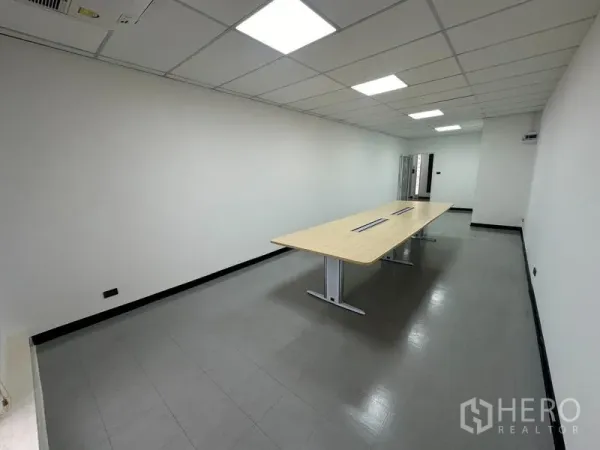 Office Space for rent - Conference room featuring a power-integrated long table and ceiling lights.