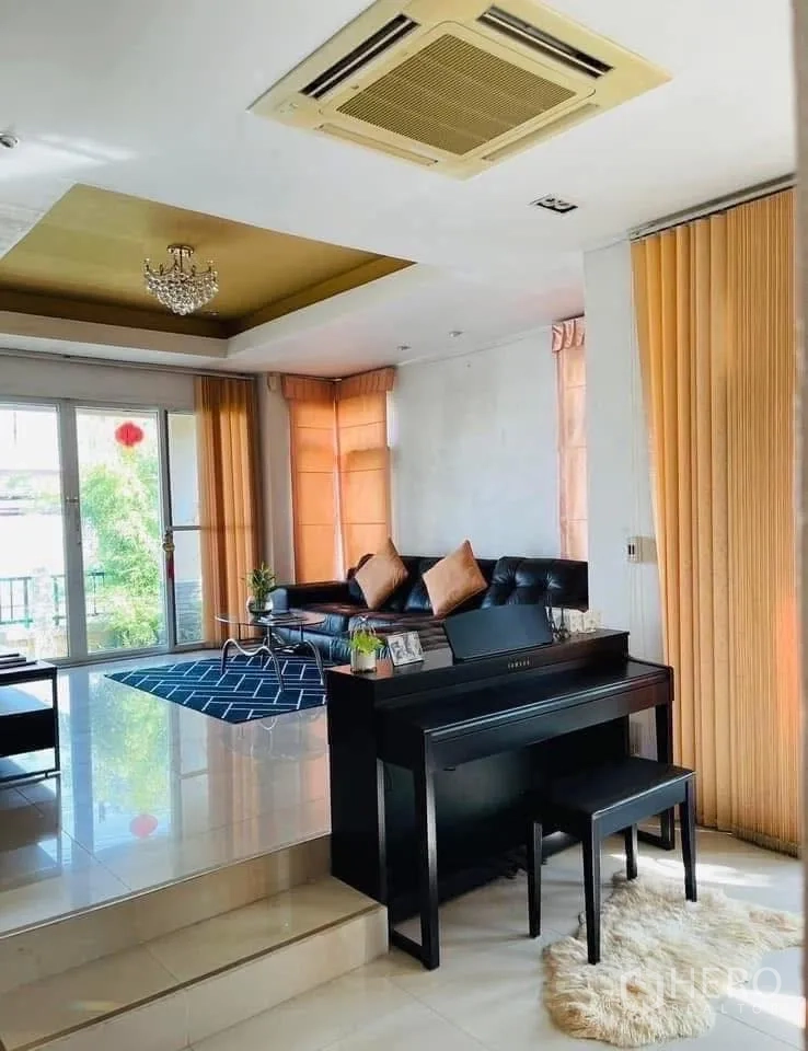 Detached House for rent or sale in Lam Luk Ka, Pathum Thani - Bright lounge with sliding glass doors, cassette ceiling air-con and piano beside sofa.