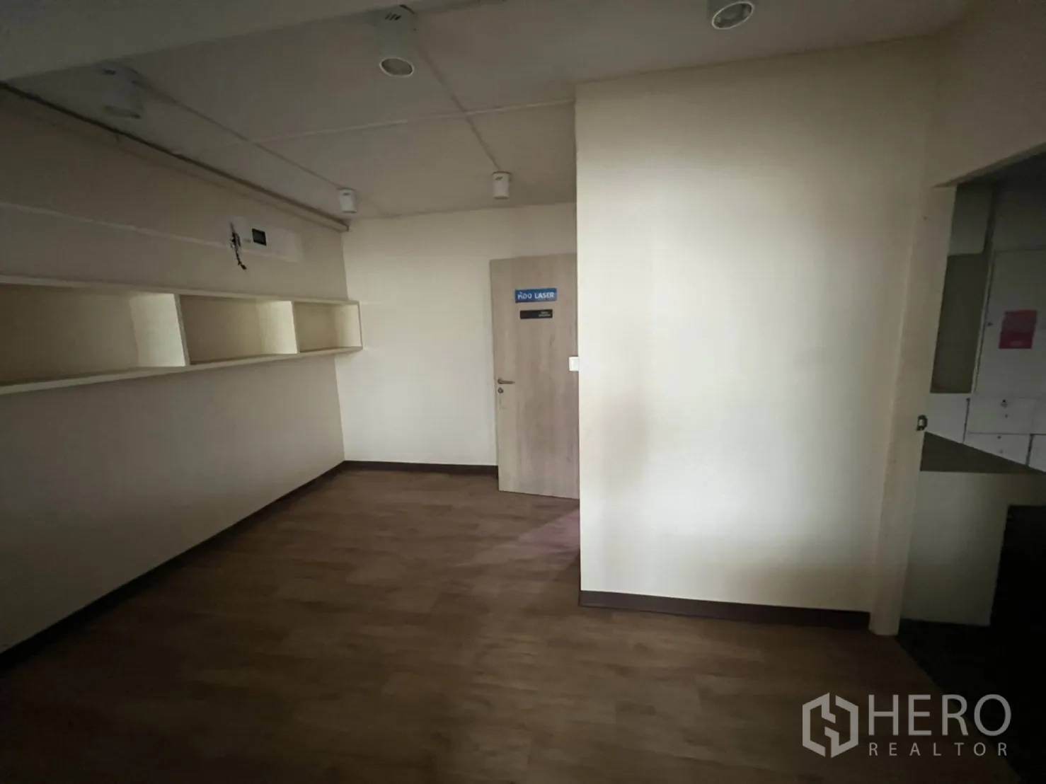 Shophouse for rent or sale in Watthana, Bangkok - Room with wall shelves and door, suitable for treatment or storage.