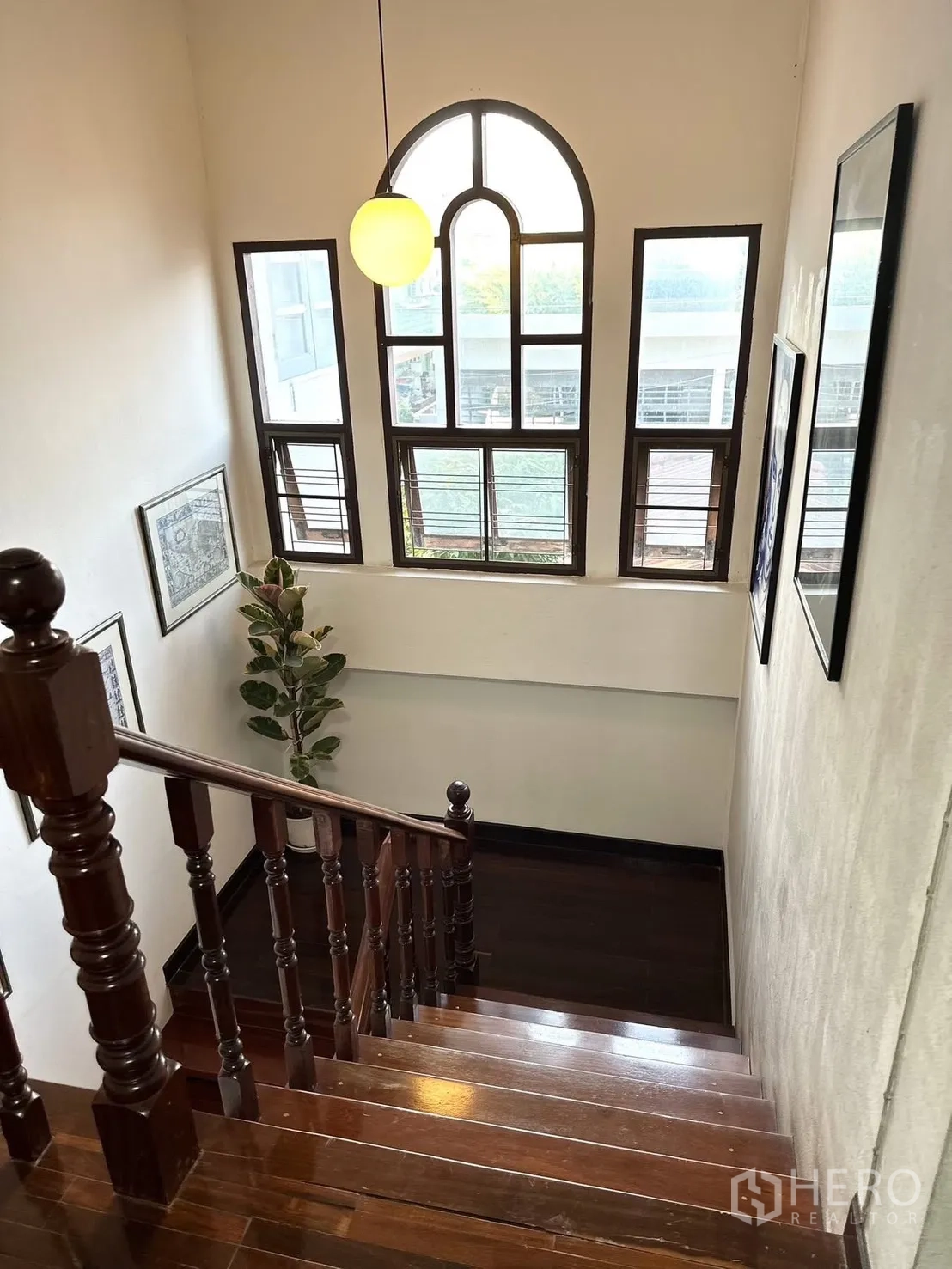 Detached House for rent in Saphan Sung, Bangkok - Wooden staircase with arched feature window and pendant light.