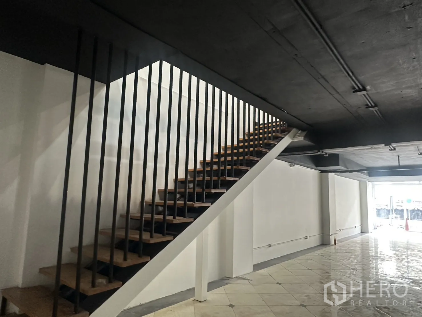 Retail Space for rent in Pathum Wan, Bangkok - Internal staircase with wooden treads and a black metal balustrade.