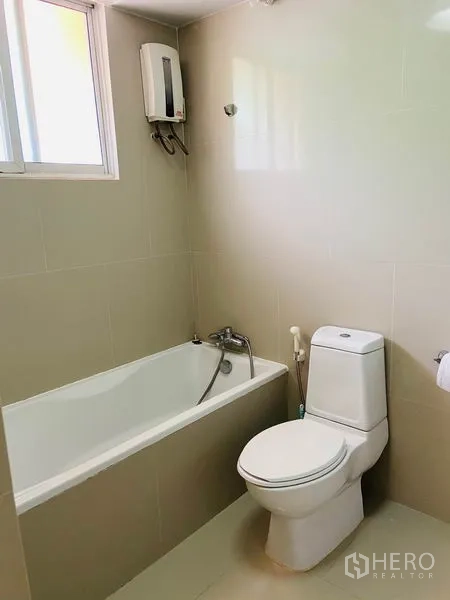 Detached House for rent in Watthana, Bangkok - Bathroom with bathtub, toilet, window and electric water heater.