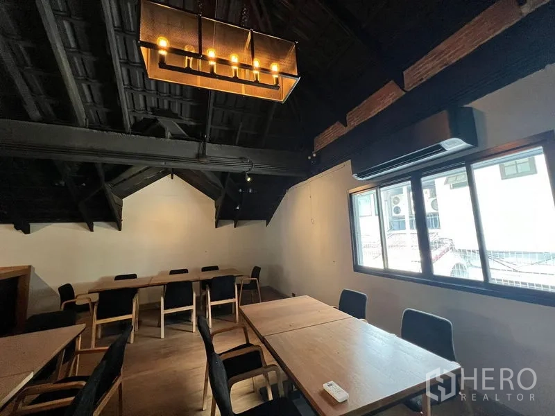 Retail Space for rent in Bangkok - Upper-floor dining room with pitched ceiling, pendant light and window.