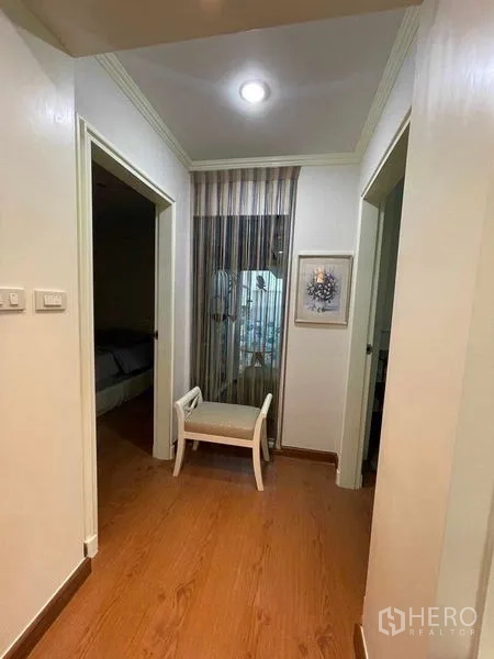 Condominium for rent - Hallway leading to bedrooms with bench and sheer partition.