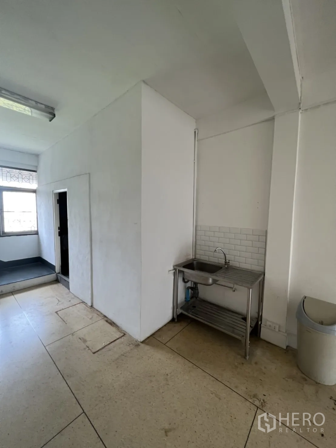 Shophouse for rent or sale in Watthana, Bangkok - Small rooftop terrace with potted plants and neighborhood view.