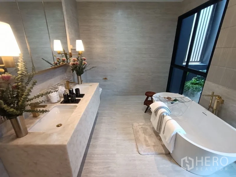 Detached House for sale - Elegant bathroom with marble counter, soaking tub beside large window and greenery.