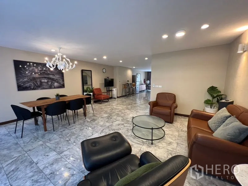 Townhouse for rent or sale in Suan Luang, Bangkok - Spacious lounge and dining area with marble floors and leather seating.